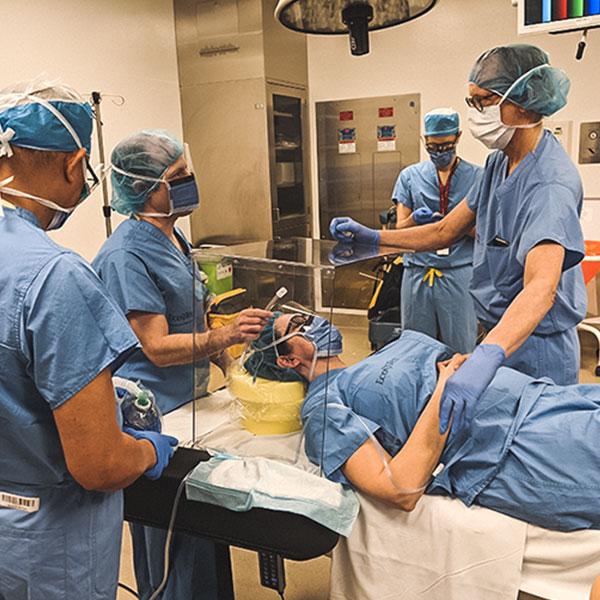 Photo of doctors using the intubation box